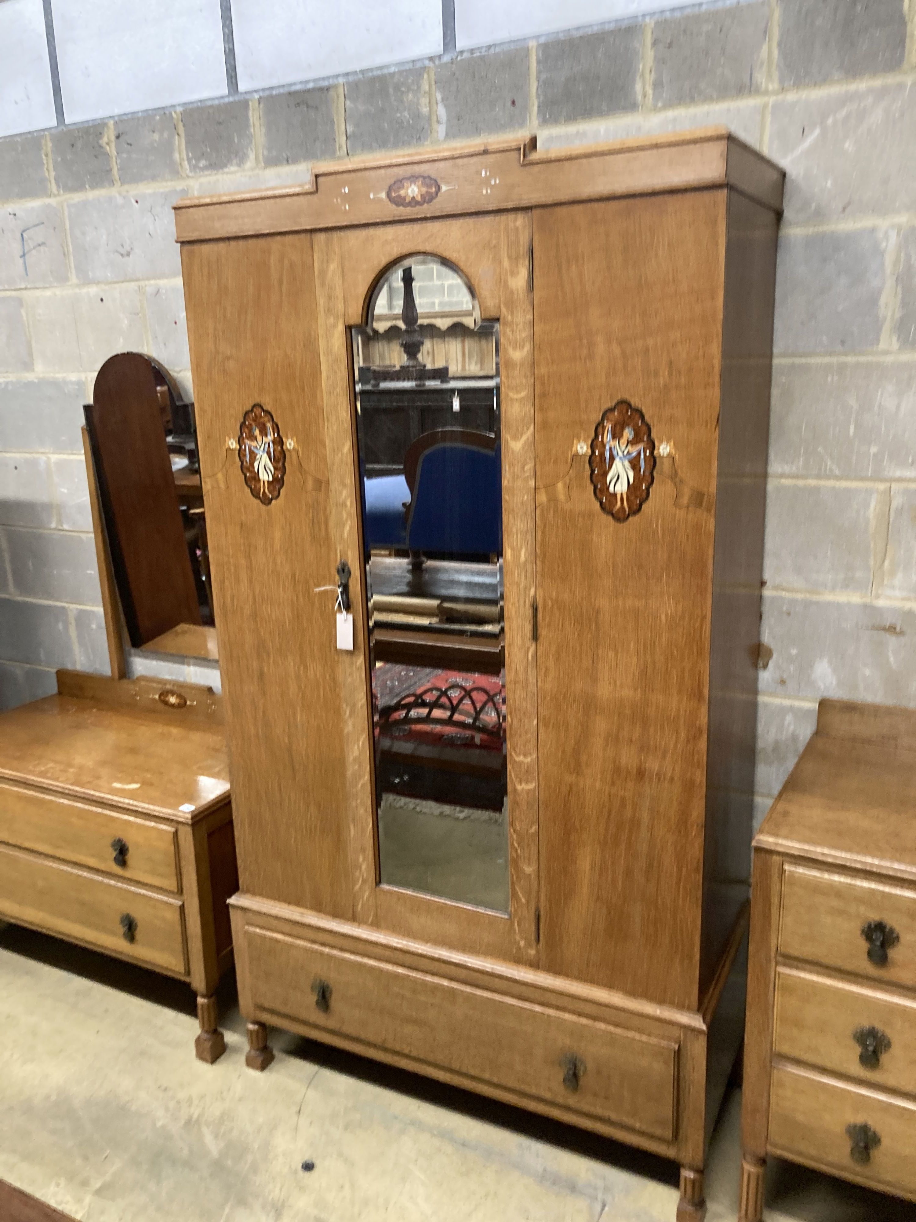 An early 20th century inlaid oak three piece bedroom suite, wardrobe width 106cm, depth 43cm, height 193cm